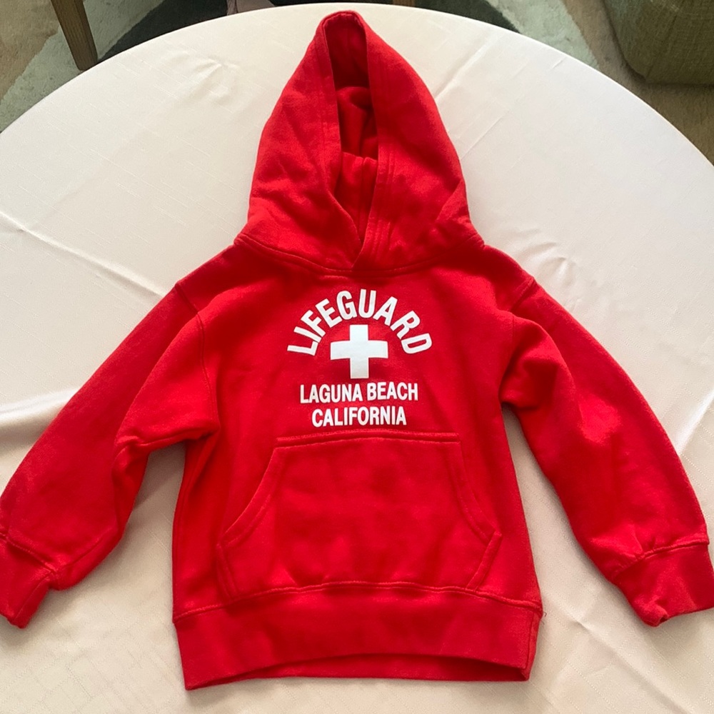 Cute trendy life guard sweater has been worn but in great condition